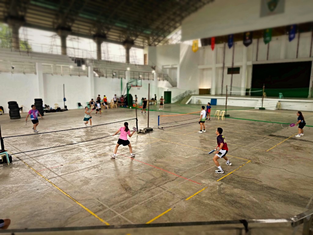 Players in open play across gym courts